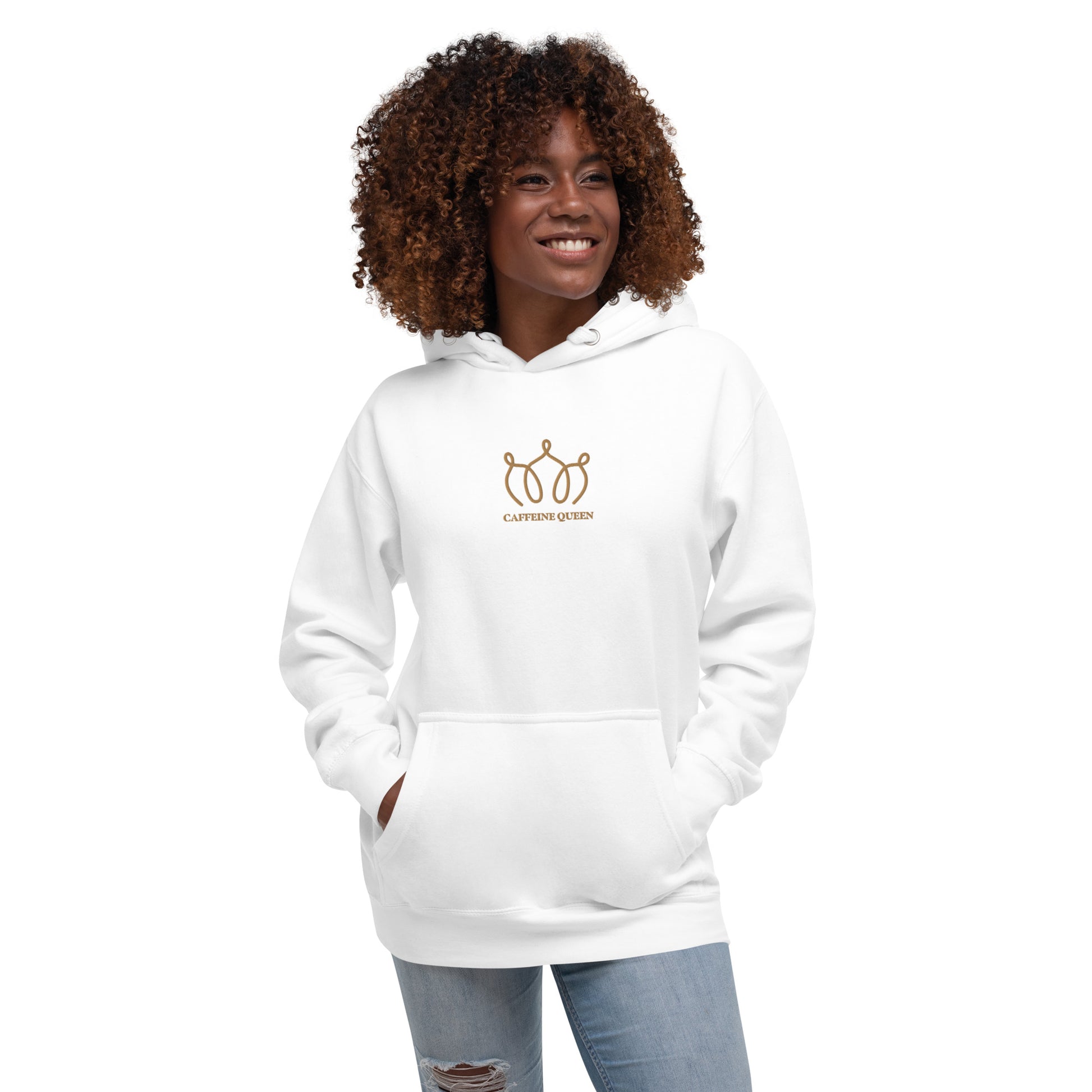 Woman wearing a white hoodie with an embroidered crown and Caffeine Queen text on the front.