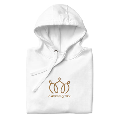 Close up of a folded white hoodie with an embroidered crown and Caffeine Queen text on the front.