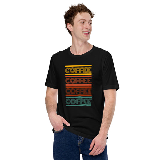 Smiling man wearing a black coffee t-shirt that has the words coffee repeated in a retro inspired font.