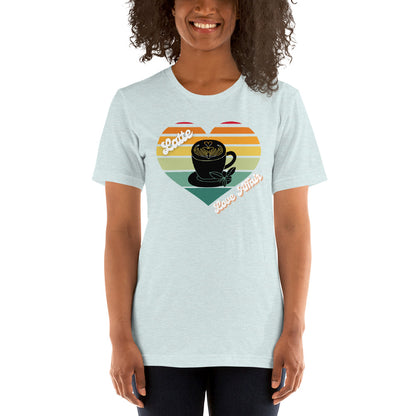Smiling woman wearing a heather prism ice blue coffee t-shirt that has a retro heart sunset and the words Latte Love Affair 