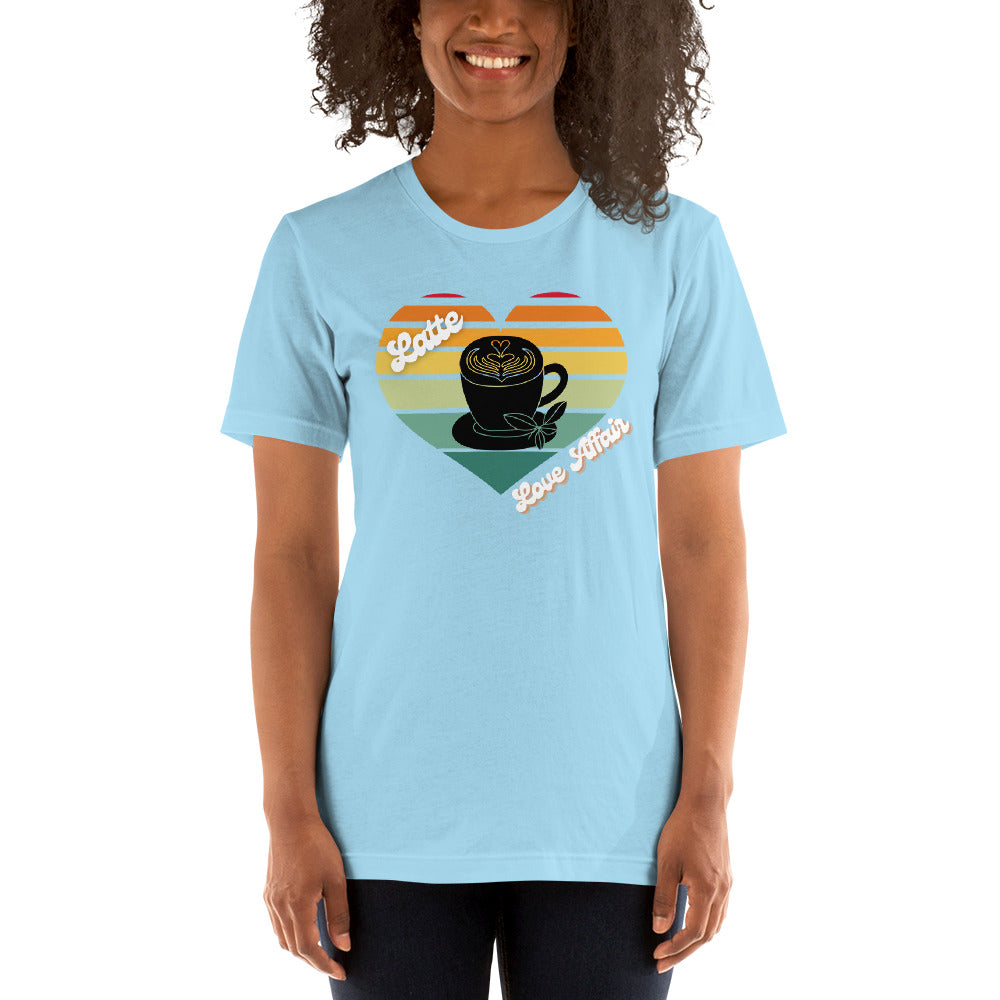 Smiling woman wearing a blue coffee t-shirt that has a retro heart sunset and the words Latte Love Affair 