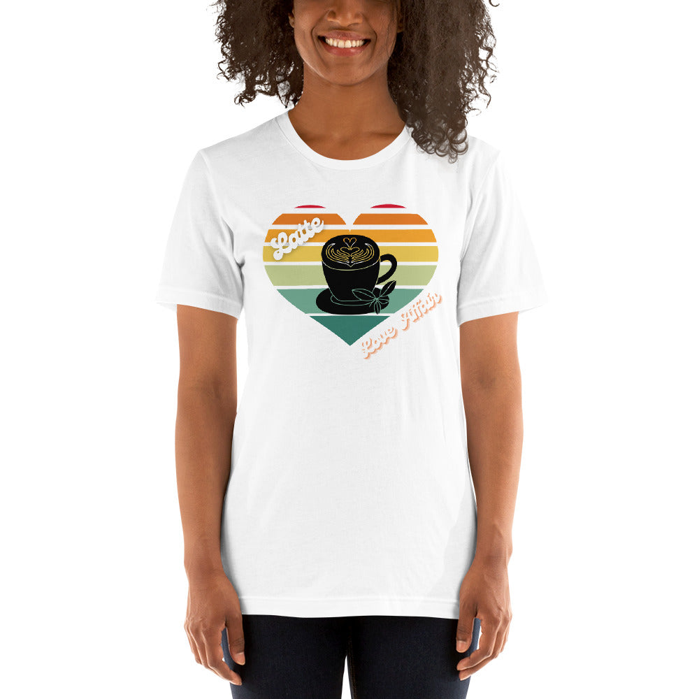 Smiling woman wearing a white coffee t-shirt that has a retro heart sunset and the words Latte Love Affair 