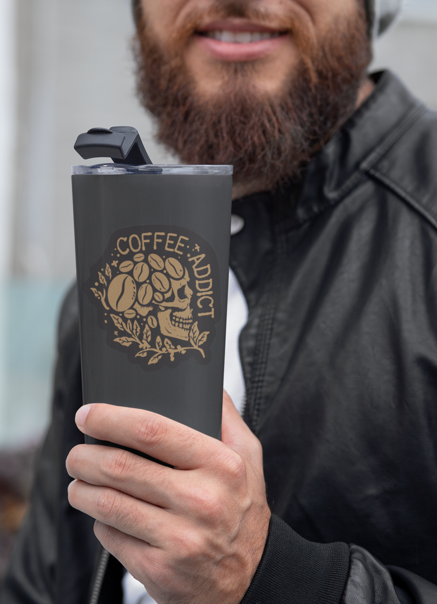 bearded man holding a travel mug with a sticker of a skull made of coffee beans with the words Coffee Addict